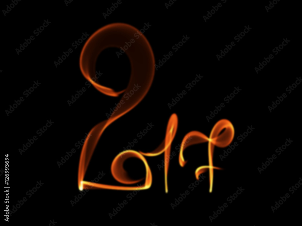 Obraz premium Happy new year 2017 isolated numbers lettering written with fire flame or smoke on black background