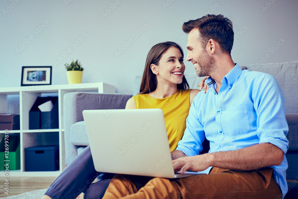 Beautiful couple at home doing online shopping Beautiful couple at home doing online shopping