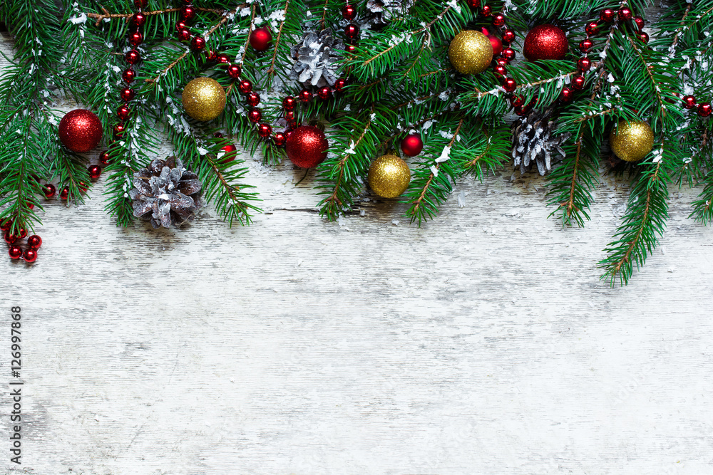 christmas background with fir branches and decorations covered with snow