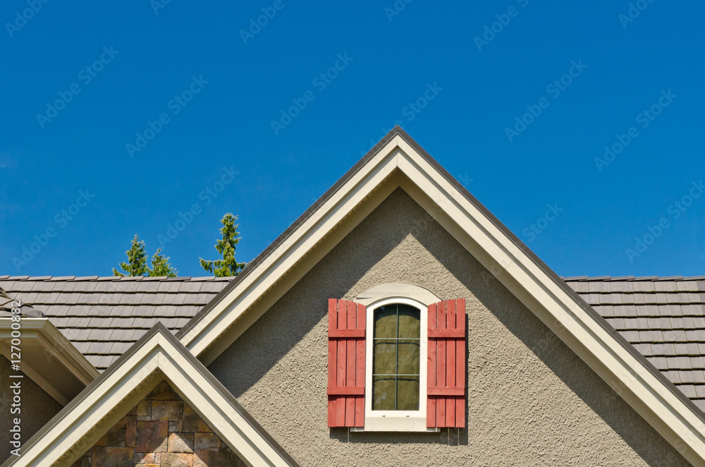 the roof of the house with nice window under the blue sky the roof of the house with nice window under the blue sky