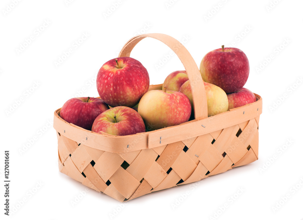 Apples in a wooden basket, on white Apples in a wooden basket, on white