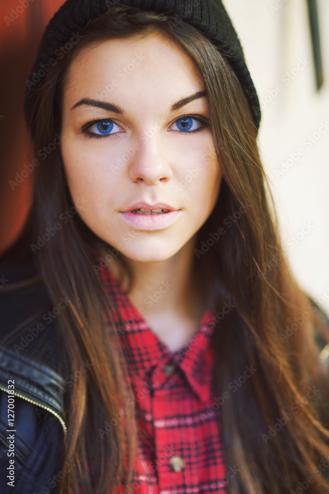 Portrait of a young successful beautiful young brunette woman in hat outdoors, close-up Portrait of a young successful beautiful young brunette woman in hat outdoors, close-up