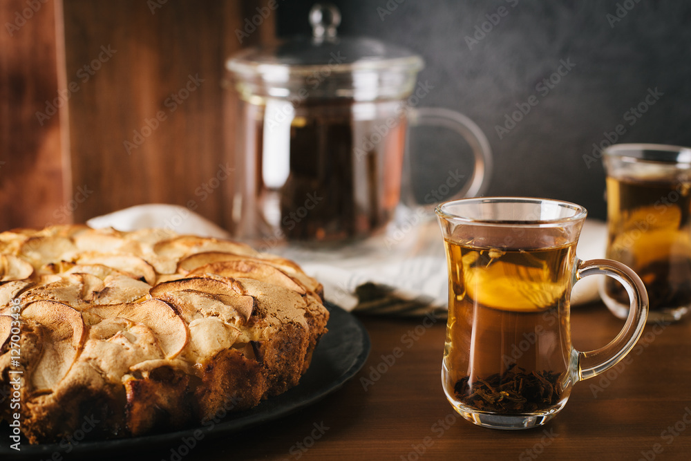 Homemade apple pie with nuts and cinnamon on dark background Homemade apple pie with nuts and cinnamon on dark background