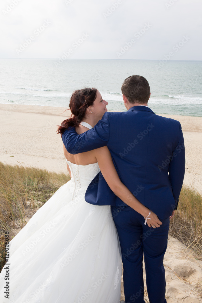 Beautiful couple on the beach in wedding dress Beautiful couple on the beach in wedding dress
