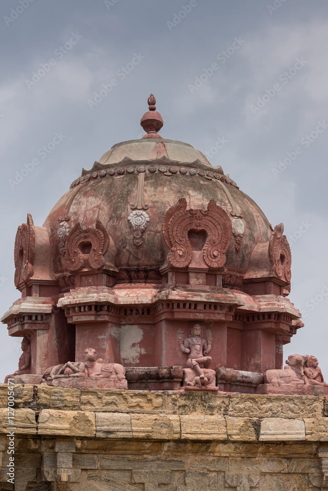 Dindigul, India - October 23, 2013: The Vimanam at the abandoned ruinous Shiva Temple on the Rock in Dindigul. Red painted dome features Dakshinamurthy Shiva and Nandi.