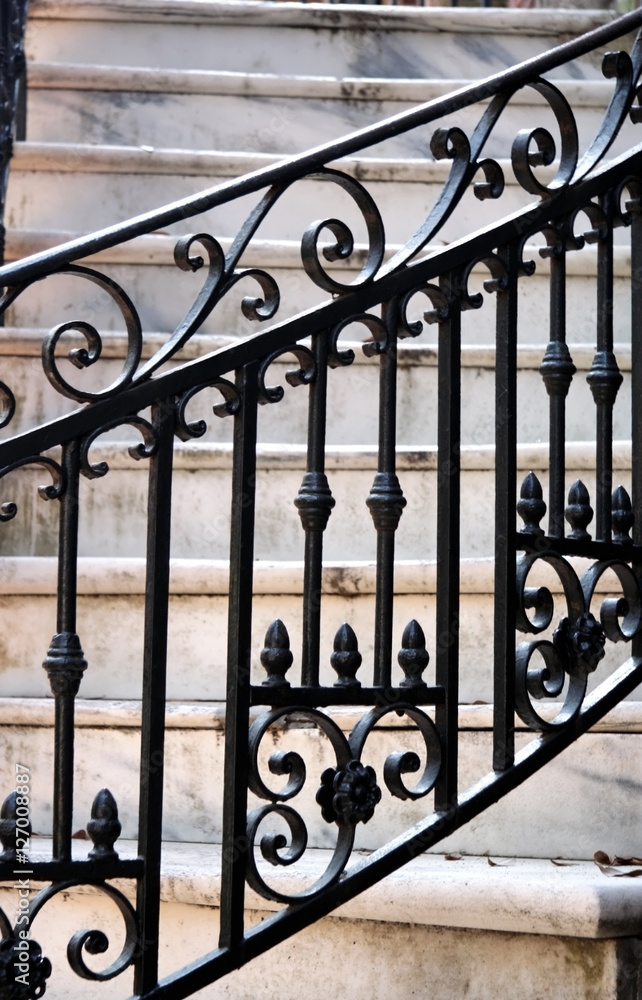 Savannah, Georgia black wrought iron railing with marble steps in background. Savannah, Georgia black wrought iron railing with marble steps in background.