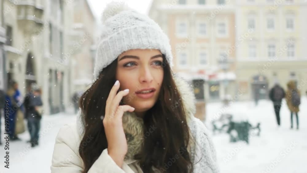 happiness, winter holidays, christmas, beverages and people concept - happy girl talking on the phone city snow winter christmas happiness, winter holidays, christmas, beverages and people concept - happy girl talking on the phone city snow winter christmas