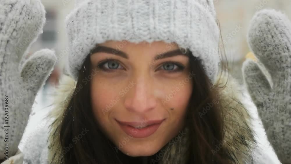 Street emotional portrait of young beautiful woman in city Model looking at camera. Lady wearing stylish classic winter knitted clothes. Christmas concept. Snowfall Street emotional portrait of young beautiful woman in city Model looking at camera. Lady wearing stylish classic winter knitted clothes. Christmas concept. Snowfall