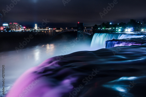 Niagara Falls light show viewed from the US side, one feet away from Bride Veil Falls. The long exposure creates a silky water effect. photo