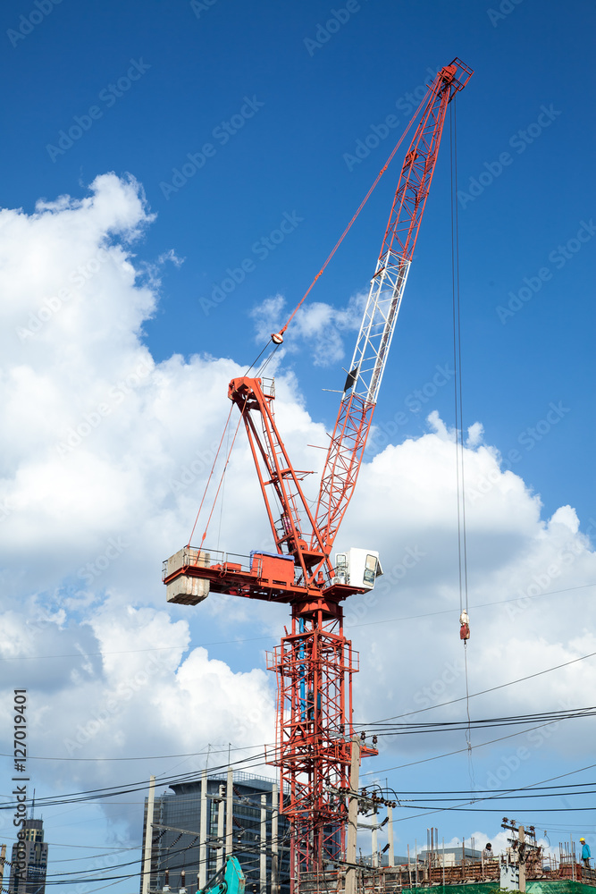 Crane working in construction site with blue sky background Crane working in construction site with blue sky background