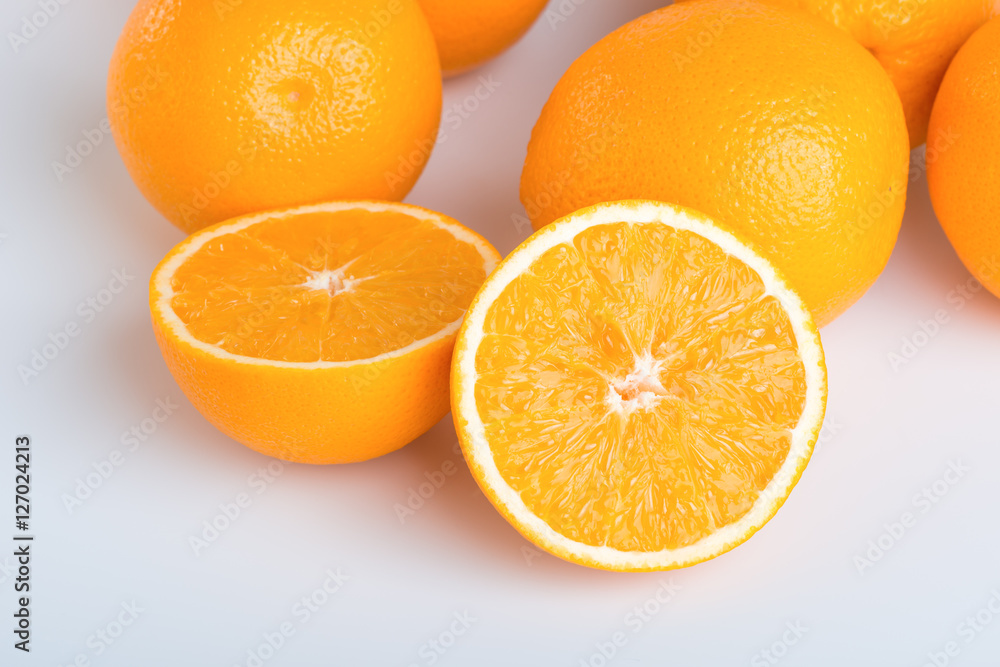 Fresh orange and cut in half on white background Fresh orange and cut in half on white background