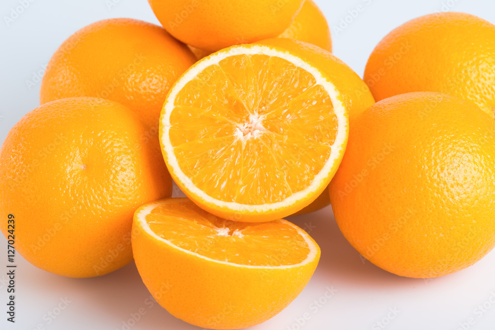Fresh orange and cut in half on white background Fresh orange and cut in half on white background