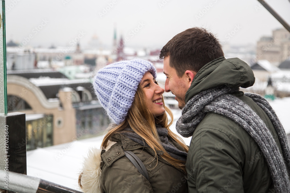 Fototapeta premium Young couple in love walking in the city, holding hands