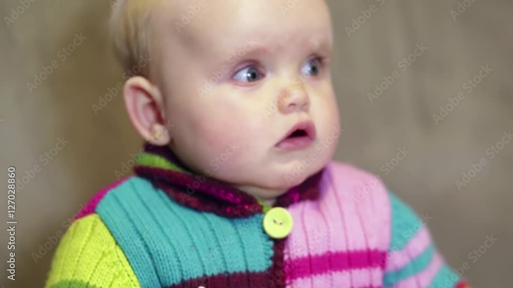 Baby girl looks around in the sitting room Baby girl looks around in the sitting room