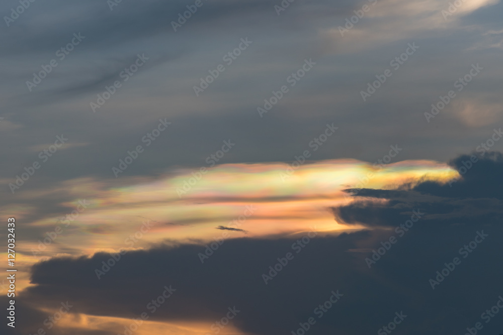 Iridescent pileus cloud at during sunset, rainbow clouds backgro