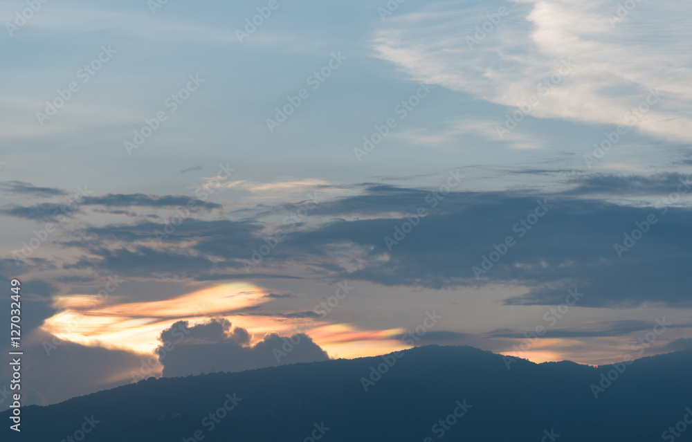 Iridescent pileus cloud at during sunset, rainbow clouds backgro