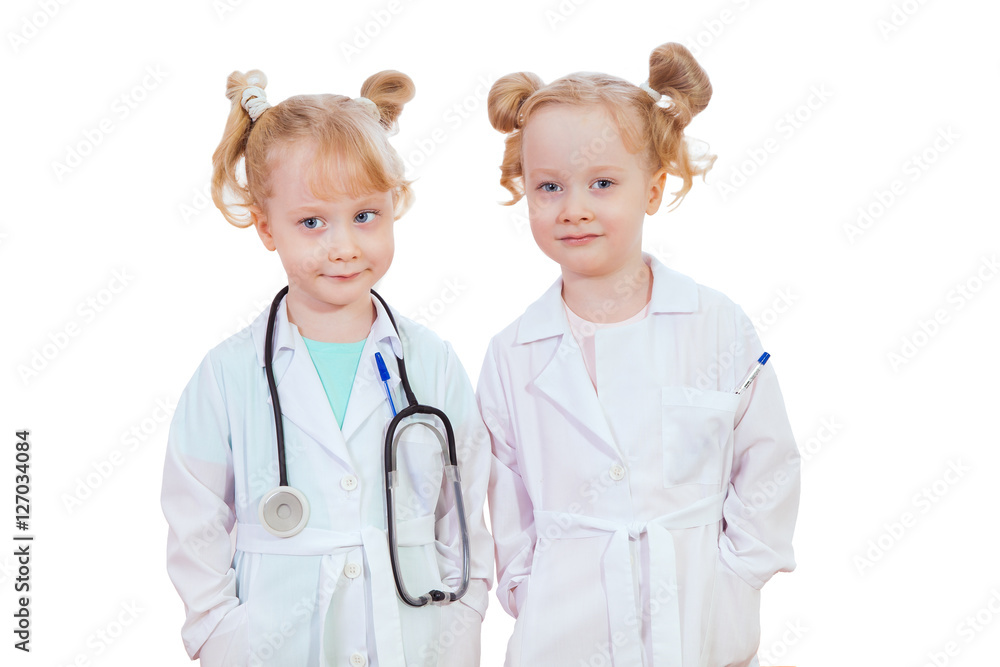 beautiful little girl twins playing doctors isolated on white background beautiful little girl twins playing doctors isolated on white background