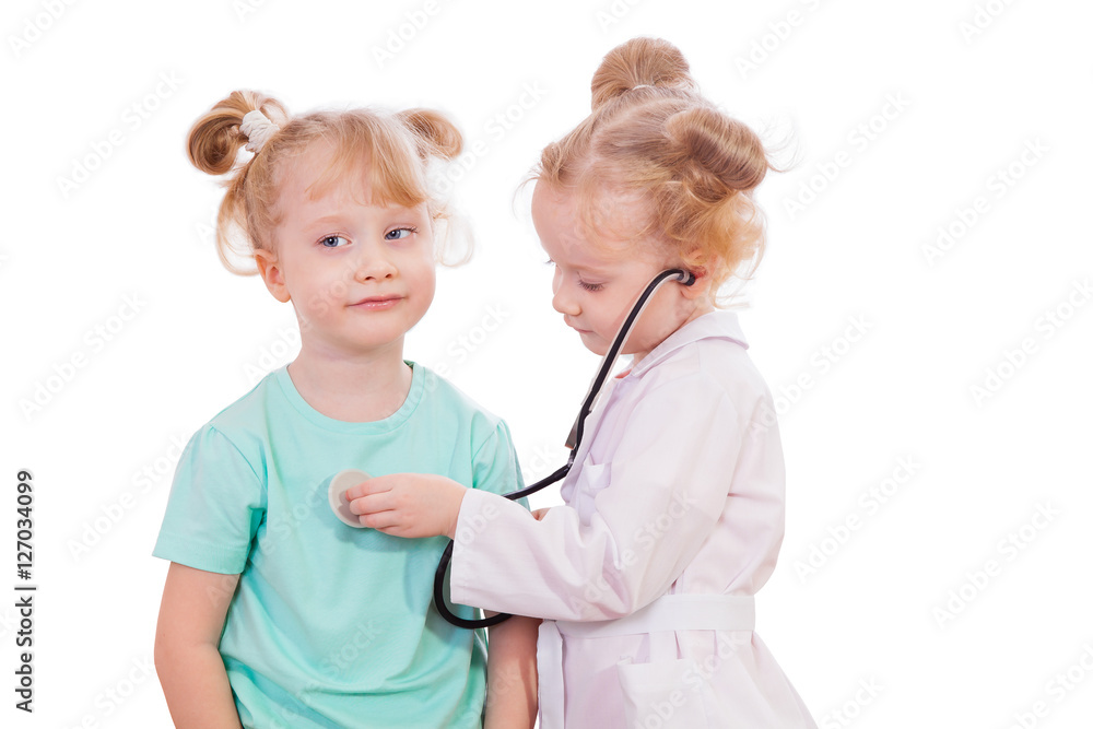 beautiful little girl twins playing doctors isolated on white background beautiful little girl twins playing doctors isolated on white background