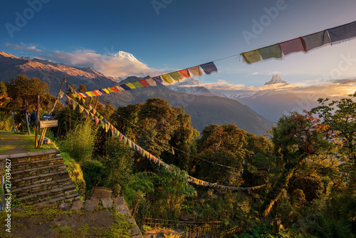 View of Mt. Annapurna and prayer flags at Sunrise from Tadapani, Nepal.