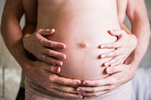 Wallpaper Mural Husband's and wife's hands on a pregnant belly Torontodigital.ca