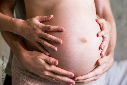 Wallpaper Mural Husband's and wife's hands on a pregnant belly Torontodigital.ca