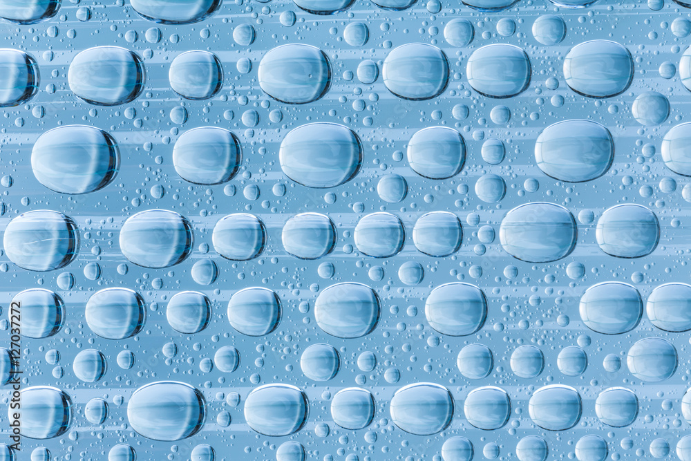 Blue water drops of on treat water-repellent surface in macro lens shot small-DOF for screen wallpapers Blue water drops of on treat water-repellent surface in macro lens shot small-DOF for screen wallpapers