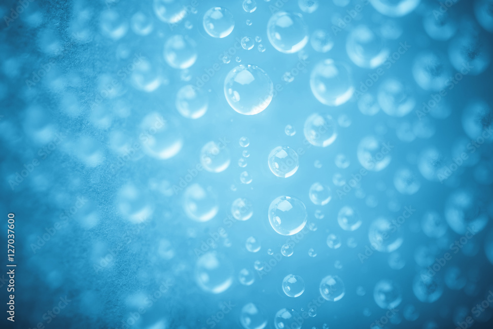 Blue water drops of on treat water-repellent surface in macro lens shot small-DOF for screen wallpapers