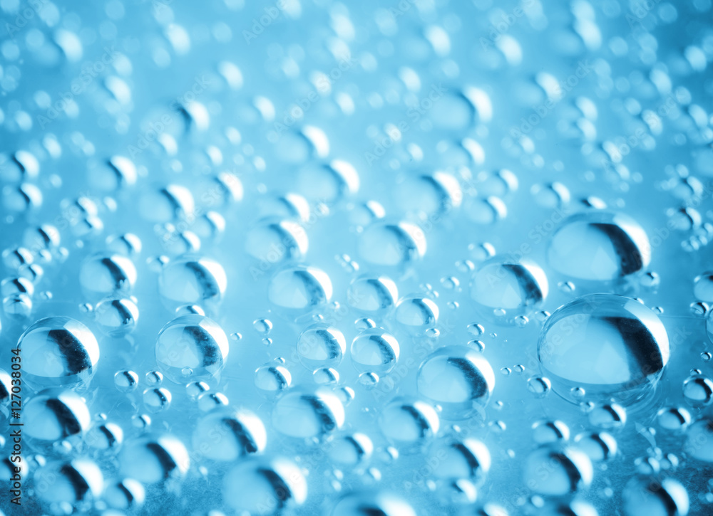 Blue water drops of on treat water-repellent surface in macro lens shot small-DOF for screen wallpapers Blue water drops of on treat water-repellent surface in macro lens shot small-DOF for screen wallpapers