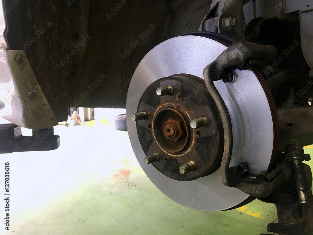 Disk break repair in the service car ,Disk break repair on the white backgroud Disk break repair in the service car ,Disk break repair on the white backgroud