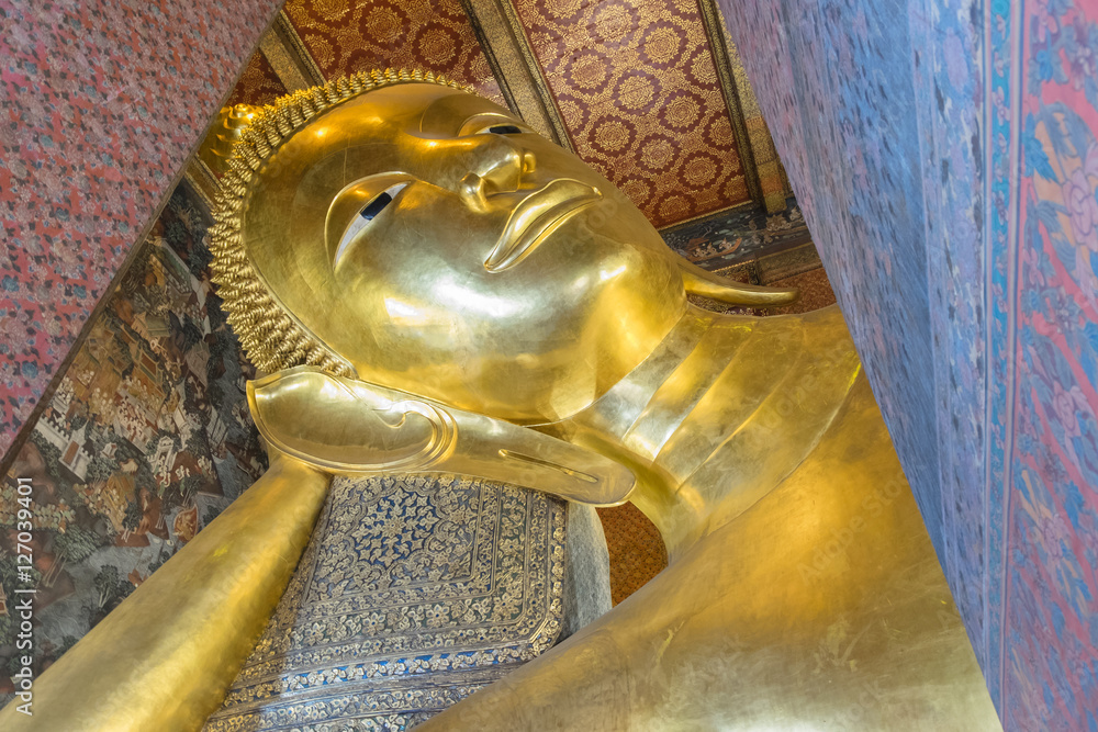 Reclining Buddha gold statue face at Wat Pho, Bangkok, Thailand
