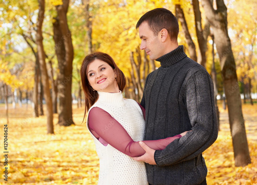 romantic people, happy adult couple embrace in autumn city park, trees with yellow leaves, bright sun and happy emotions, tenderness and feelings romantic people, happy adult couple embrace in autumn city park, trees with yellow leaves, bright sun and happy emotions, tenderness and feelings