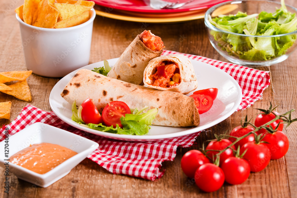 Tortilla wraps with chicken and vegetable.