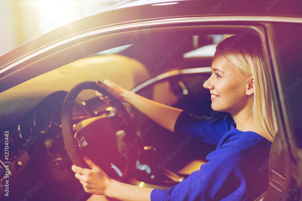 happy woman inside car in auto show or salon happy woman inside car in auto show or salon