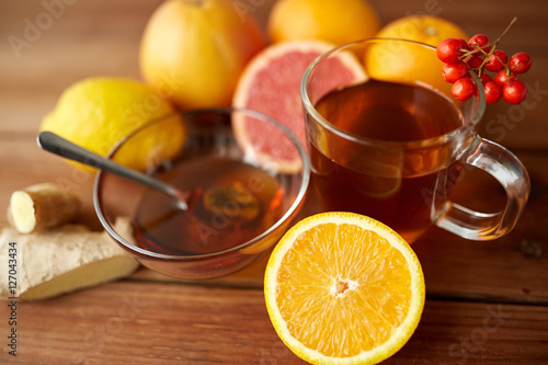 tea with honey, orange and rowanberry on wood
