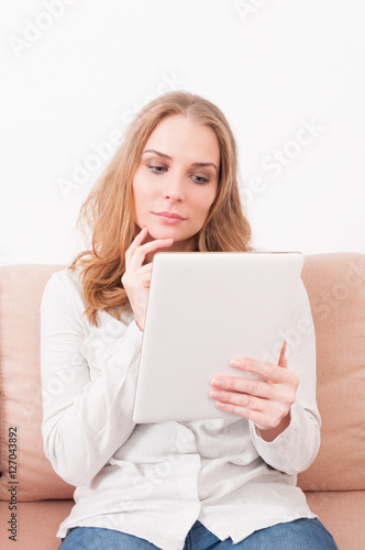 Wallpaper Mural Lady laying on couch being pensive looking on tablet Torontodigital.ca