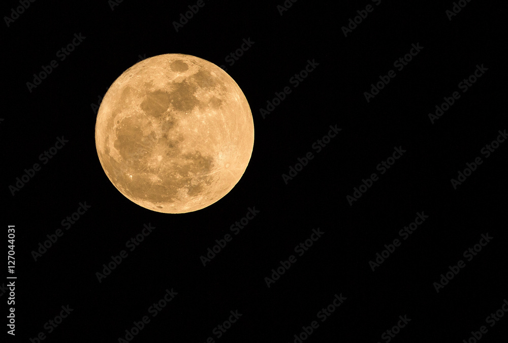 Fototapeta premium Full moon over dark black sky at night.