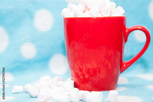 marshmallow in a red cup on a blue background