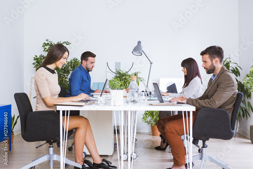 Men and women working in office