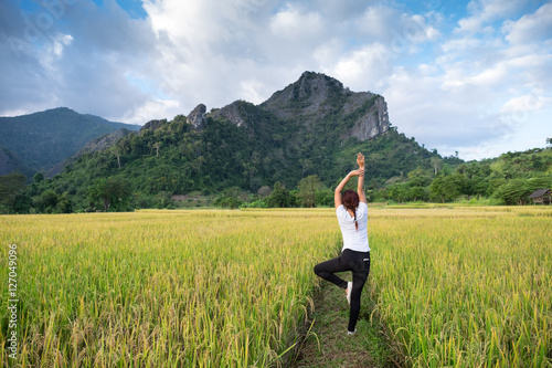 women standing exercise in the paddy on mountain background