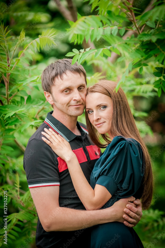 Dating. Young woman and man walking, couple in love relaxing in blossoming trees park at sunny spring day Dating. Young woman and man walking, couple in love relaxing in blossoming trees park at sunny spring day