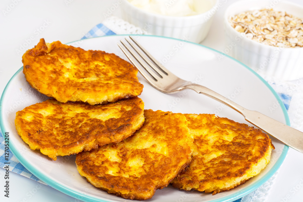 Pumpkin-oatmeal pancakes with curry on a white background