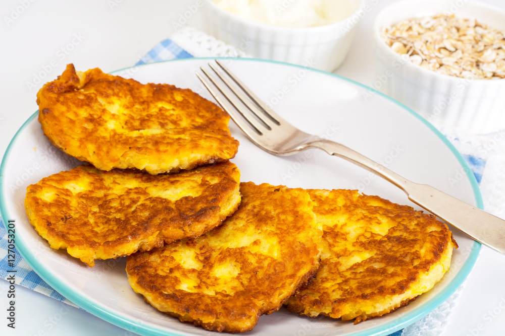 Pumpkin-oatmeal pancakes with curry on a white background Pumpkin-oatmeal pancakes with curry on a white background