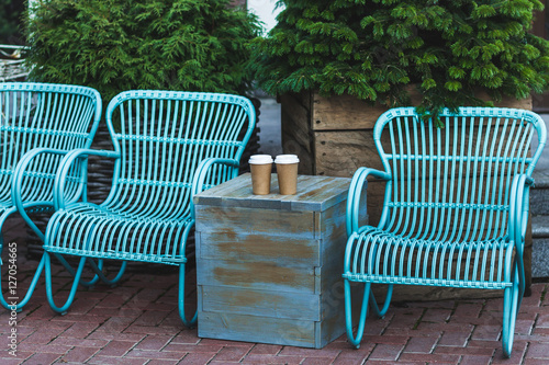 Two cup coffee to go on blue vintage table in beautiful cafe out