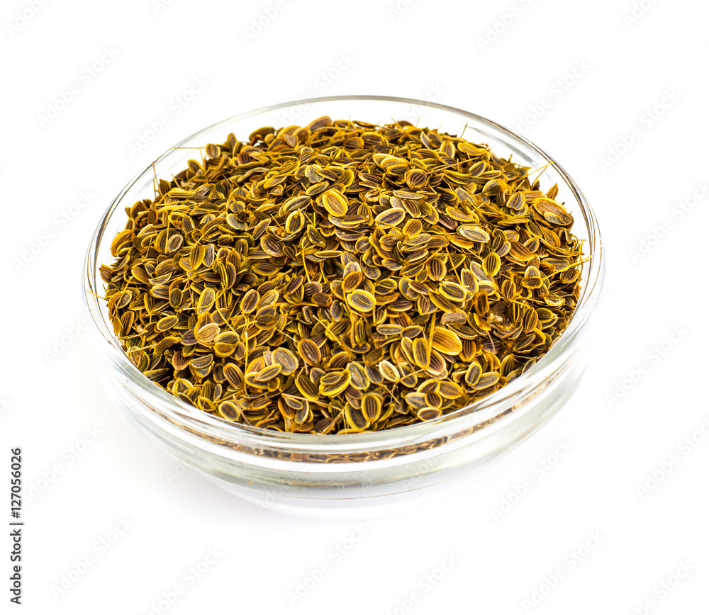 Fennel Seeds in a Glass Bowl on a White Fennel Seeds in a Glass Bowl on a White