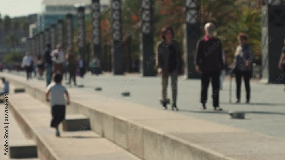 Unfocused background video of unrecognizable people walking in sunny weekend day on crowded pedestrian street Unfocused background video of unrecognizable people walking in sunny weekend day on crowded pedestrian street