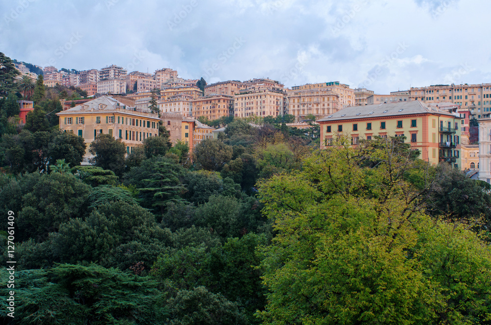 Building of Genoa, Italy, over the trees of the city in autumn.