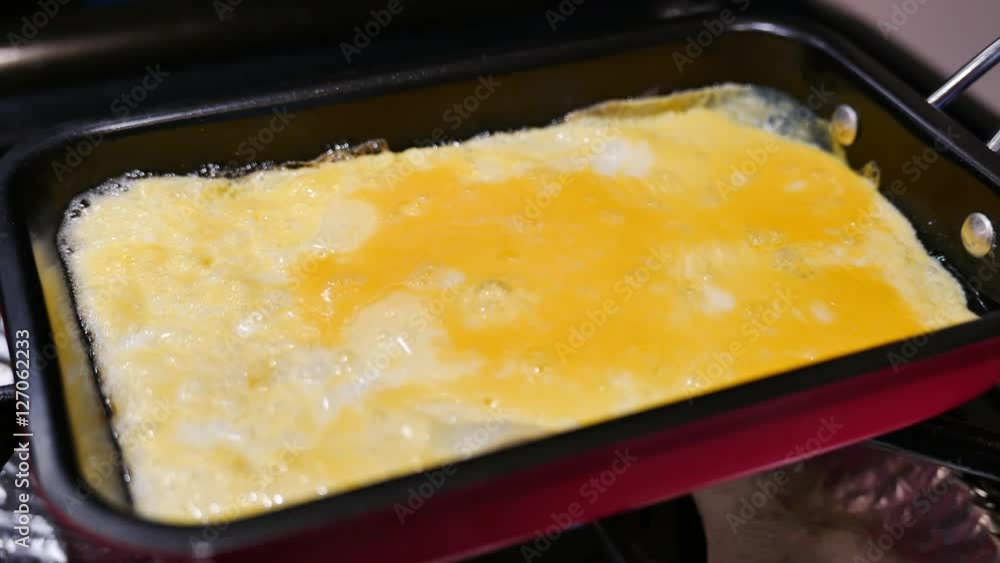 Frying delicious egg omelette at home with a pan Frying delicious egg omelette at home with a pan