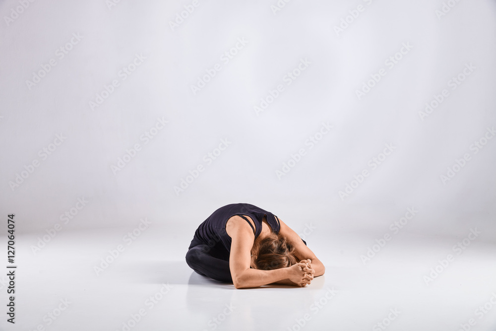 Woman doing yoga isolated on white background