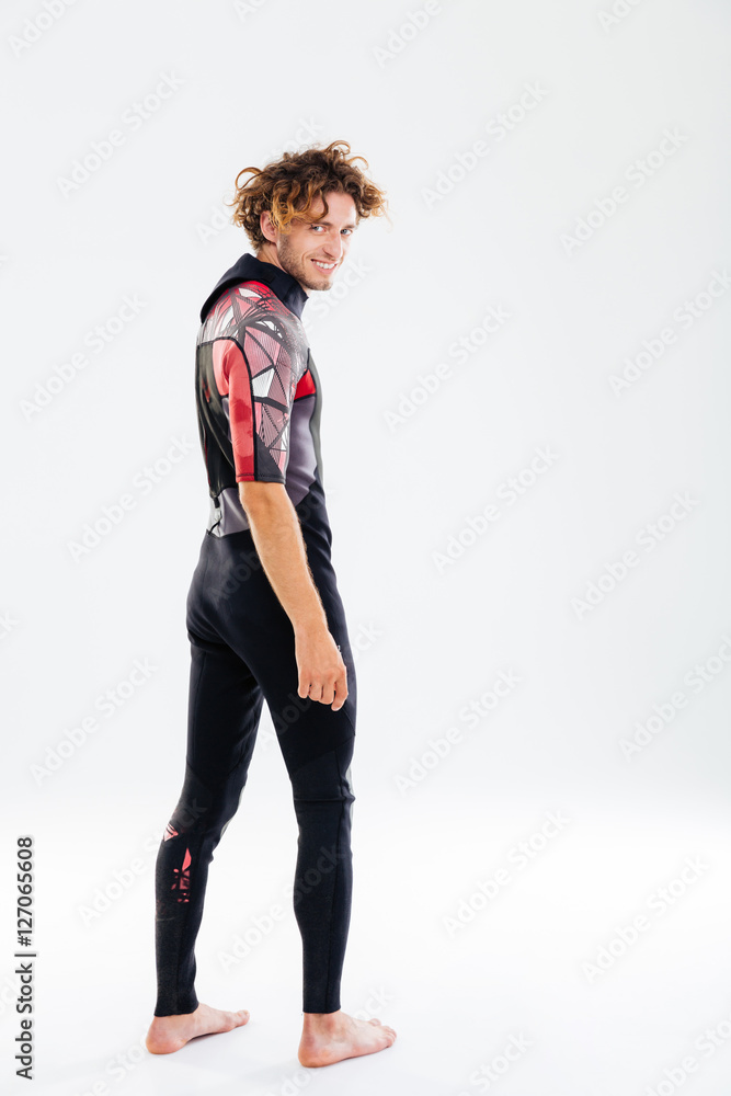 Smiling happy man in diving suit looking over his shoulder Smiling happy man in diving suit looking over his shoulder