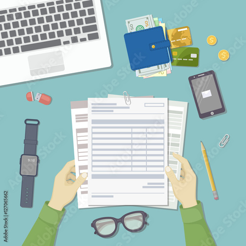 Man working with documents. Men's hands hold the accounts, payroll, tax form. Workplace with papers, blanks, laptop, phone with message, smart watches, wallet with money, credit cards. Top view Vector